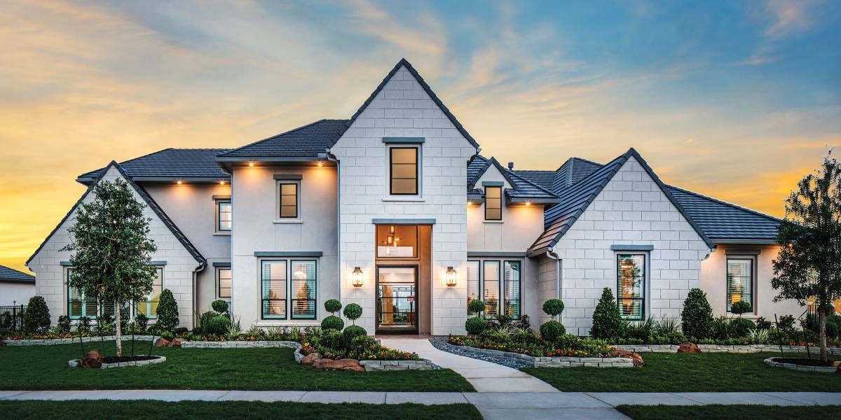 Custom home built by Brixton Build in Houston, Texas at dusk with warm interior lighting